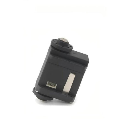 Angled side view of servo motor showing housing profile, mounting holes, and plug socket