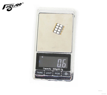 FLYWOO frame arm LED board light on a digital scale, compact PCB with multiple LEDs, 0.6 g weight