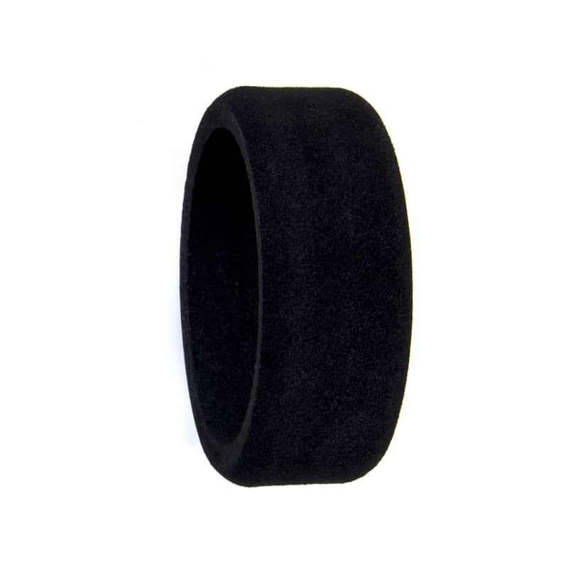 Black foam steering wheel cover, side profile showing thickness and smooth outer surface