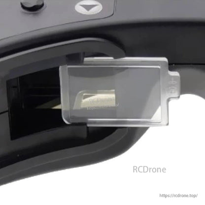 Installed diopter lens view in analog FPV goggles, showing lens tab and holder fit (RCDRone watermark)