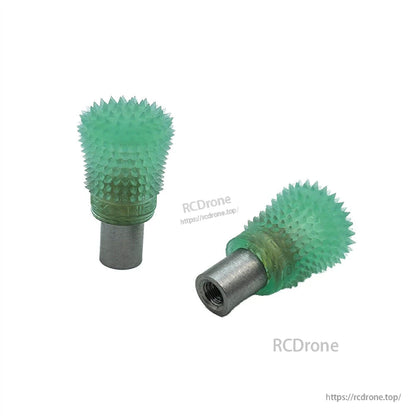 Green spiked thumb stick ends pair on white background, one showing threaded metal opening