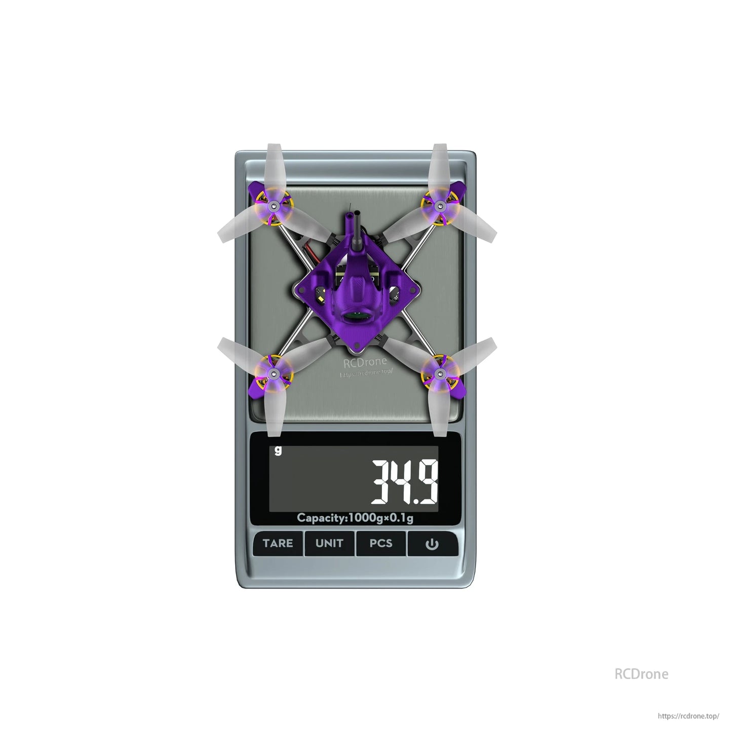 Firefly Nano Baby V3-style micro quadcopter on a digital scale showing 34.9 g weight