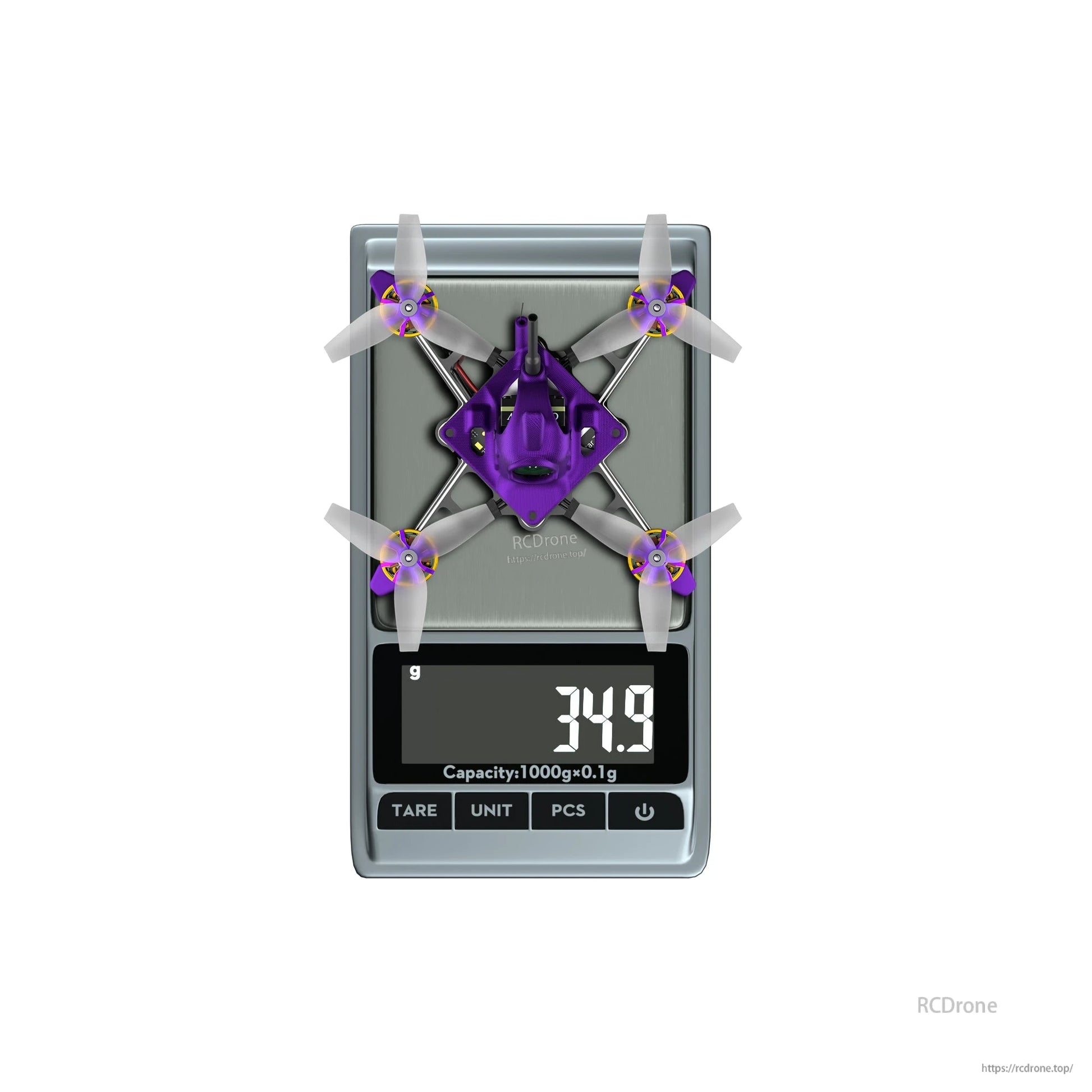 Firefly Nano Baby V3-style micro quadcopter on a digital scale showing 34.9 g weight