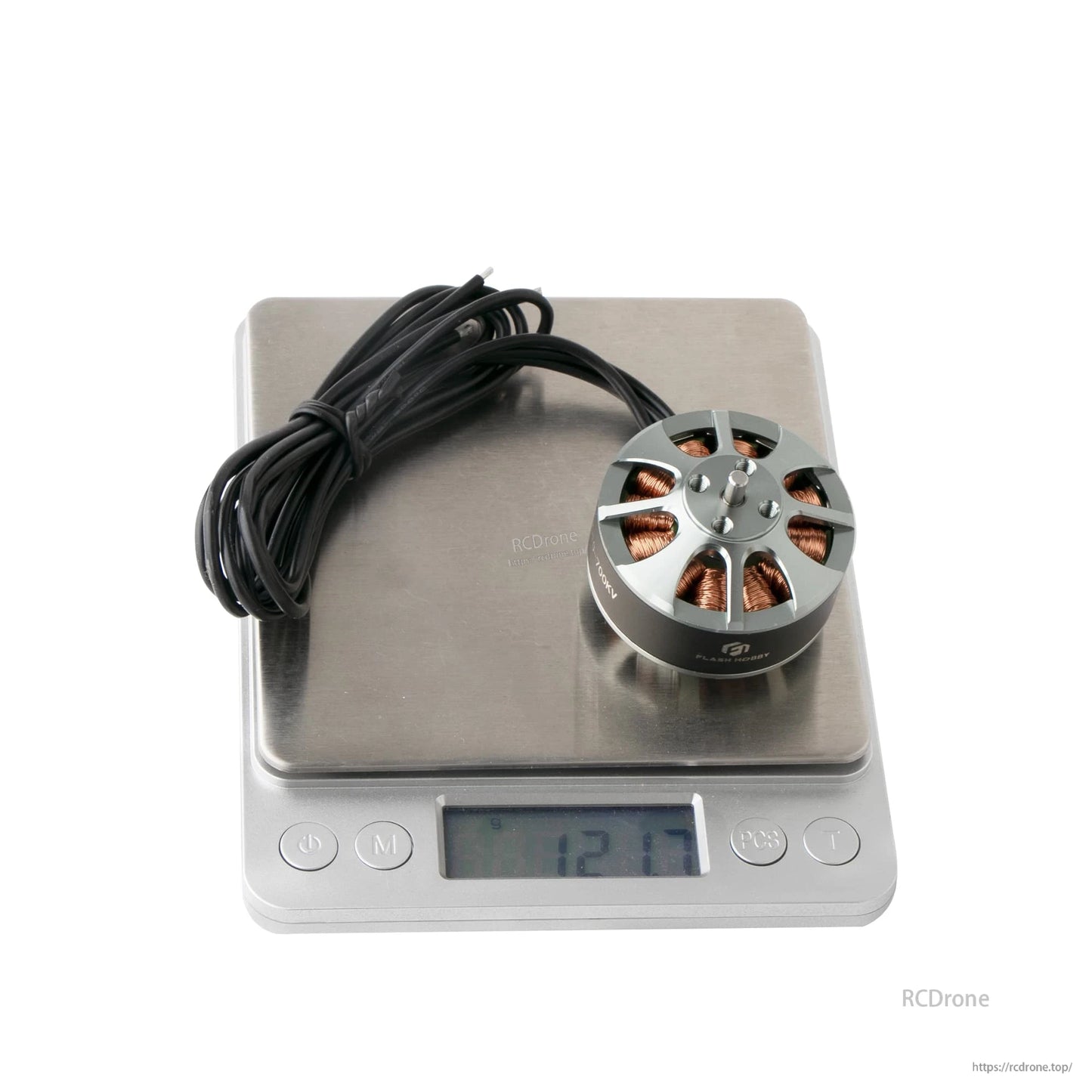 Flashhobby 3510 brushless DC motor with attached wires on a digital scale reading 121.7 g