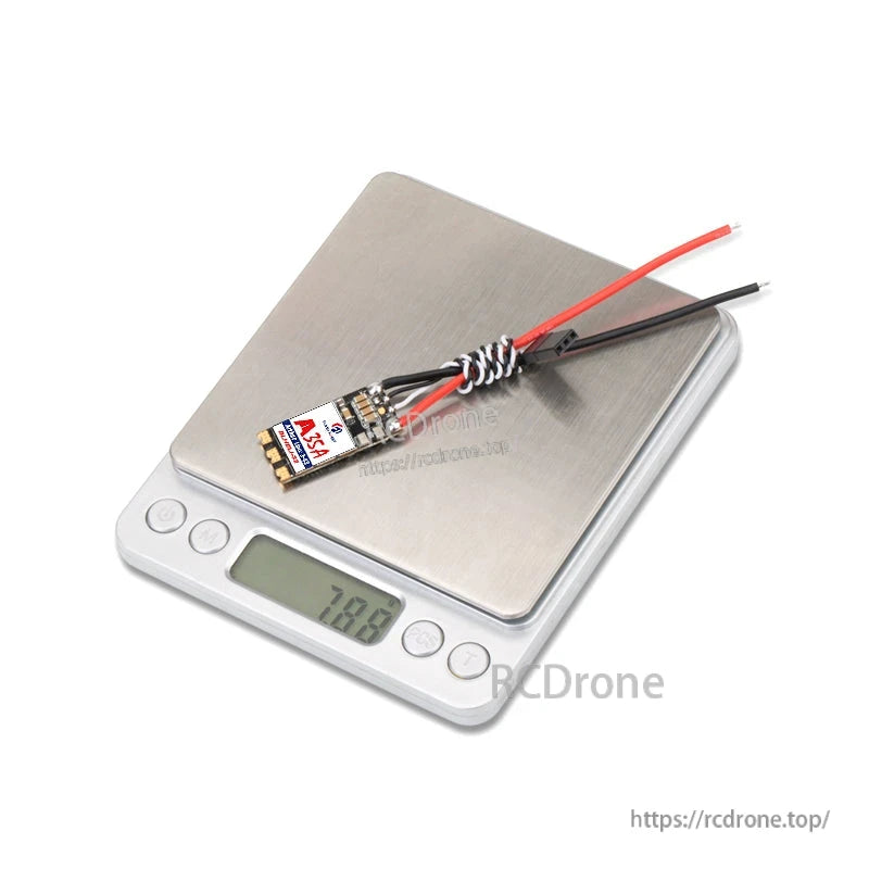 Flashhobby Arthur 35A 3-6S BLHeli_32 32-bit ESC, Flashhobby Arthur 35A BLHeli_32 32-bit ESC with red and black power leads on a digital scale reading 20.9 g