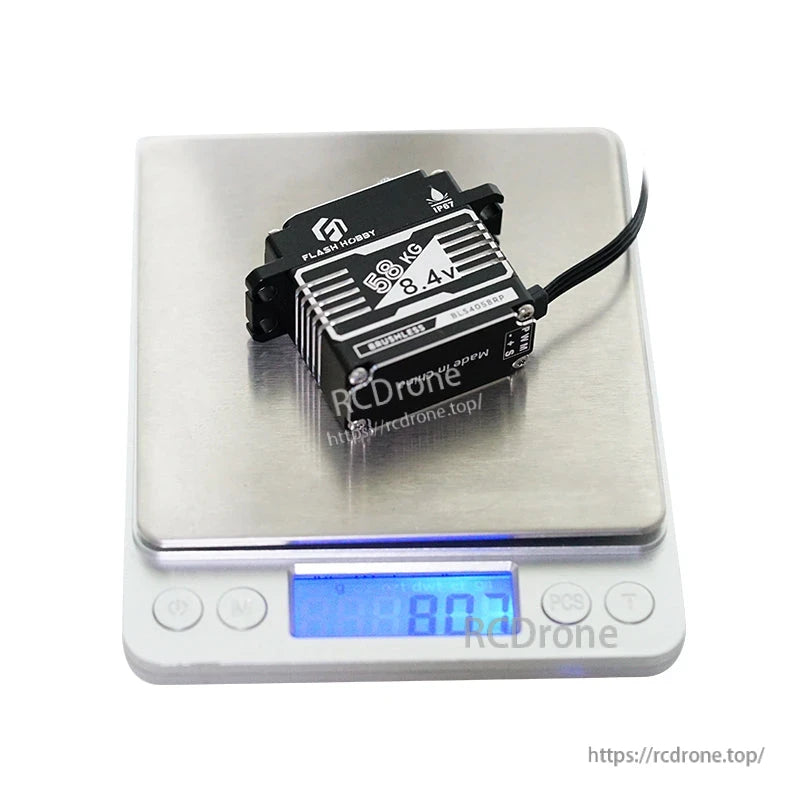 Flashhobby BLS4058RP Servo, Flashhobby BLS4058RP brushless servo labeled 66kg 8.4V, photographed on a digital scale showing about 80g