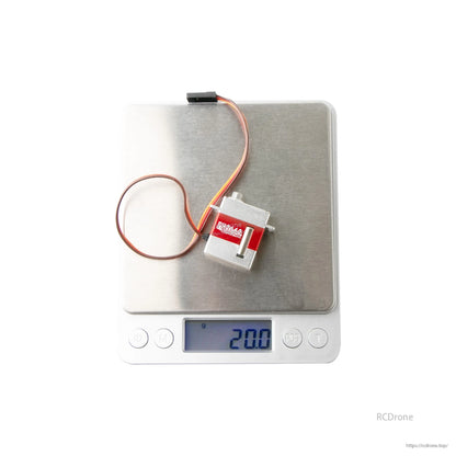 Flashhobby FH-2162 micro servo with 3-wire lead on a digital scale showing 20.0 g weight