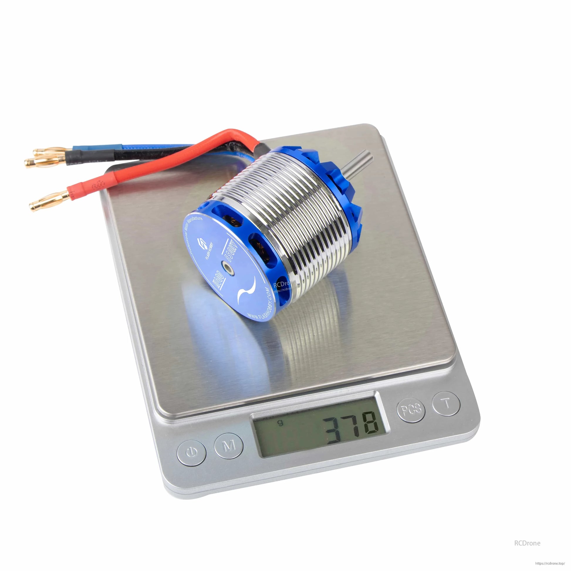 Flashhobby H600 550KV helicopter motor with blue end bell and bullet connector leads, shown on a scale at 378 g