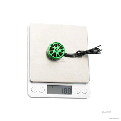 Flashhobby K2303 1750KV brushless motor with green top on a digital scale reading 18.8 g