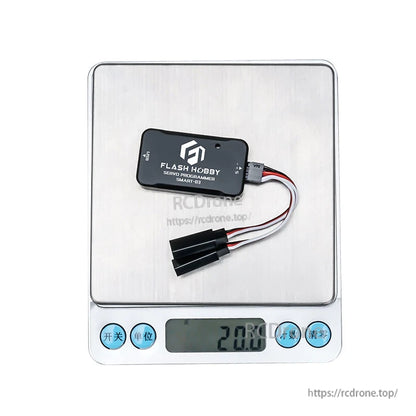 Flashhobby SMART-03 servo programmer module with USB port and 3-wire servo lead, shown on a scale at 20 g