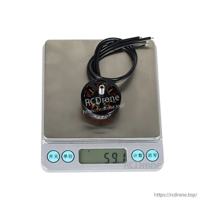 Flashhobby X2807 brushless DC motor with lead wires on a digital scale reading 59.1 g