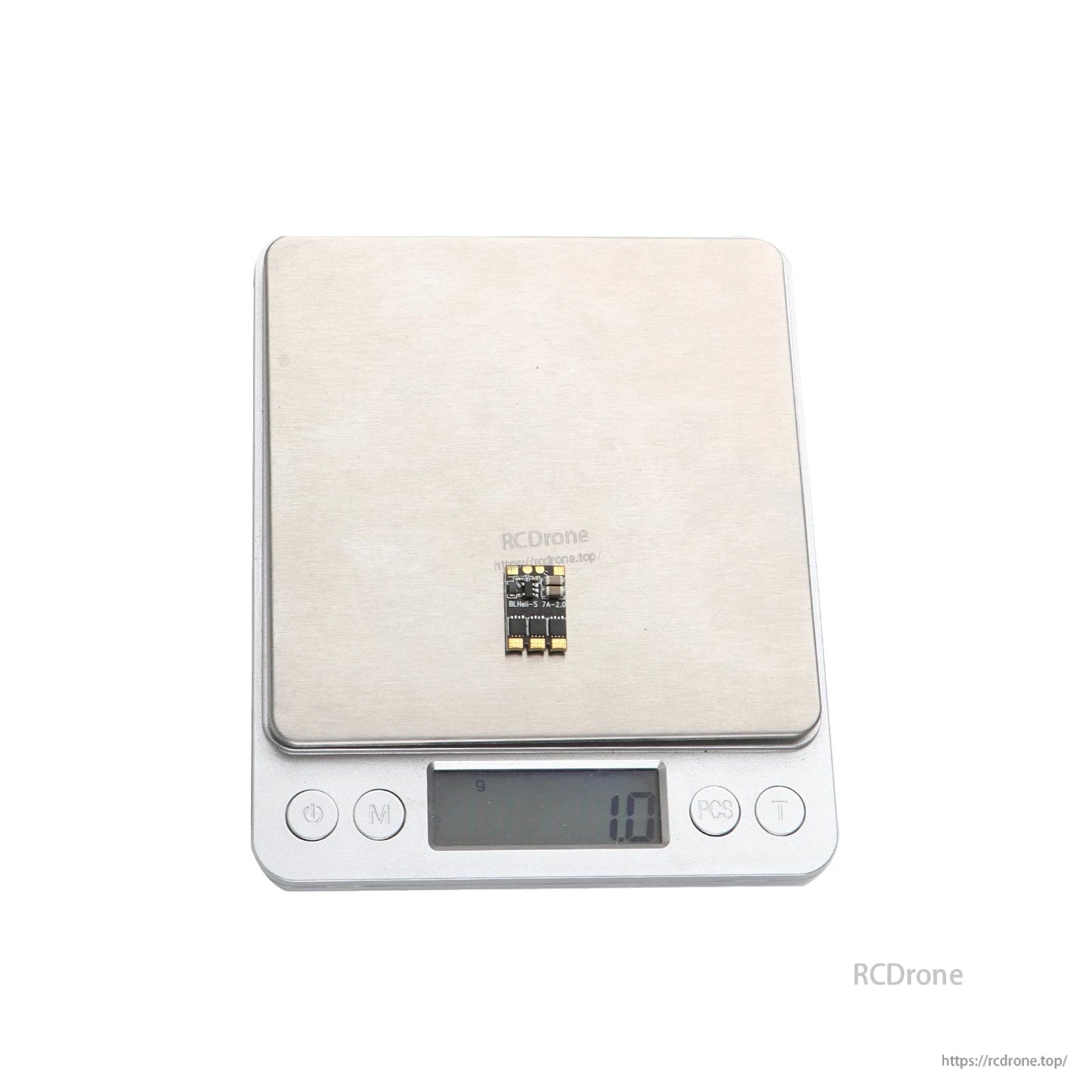 Micro BLHeli_S 7A brushless ESC board on digital scale, compact layout with solder pads, 1.0g reading