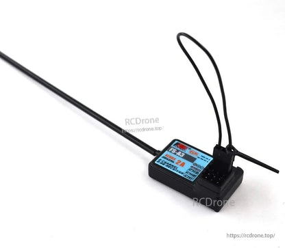 Receiver with long antenna wire extended, showing overall cable routing and connector end on tabletop