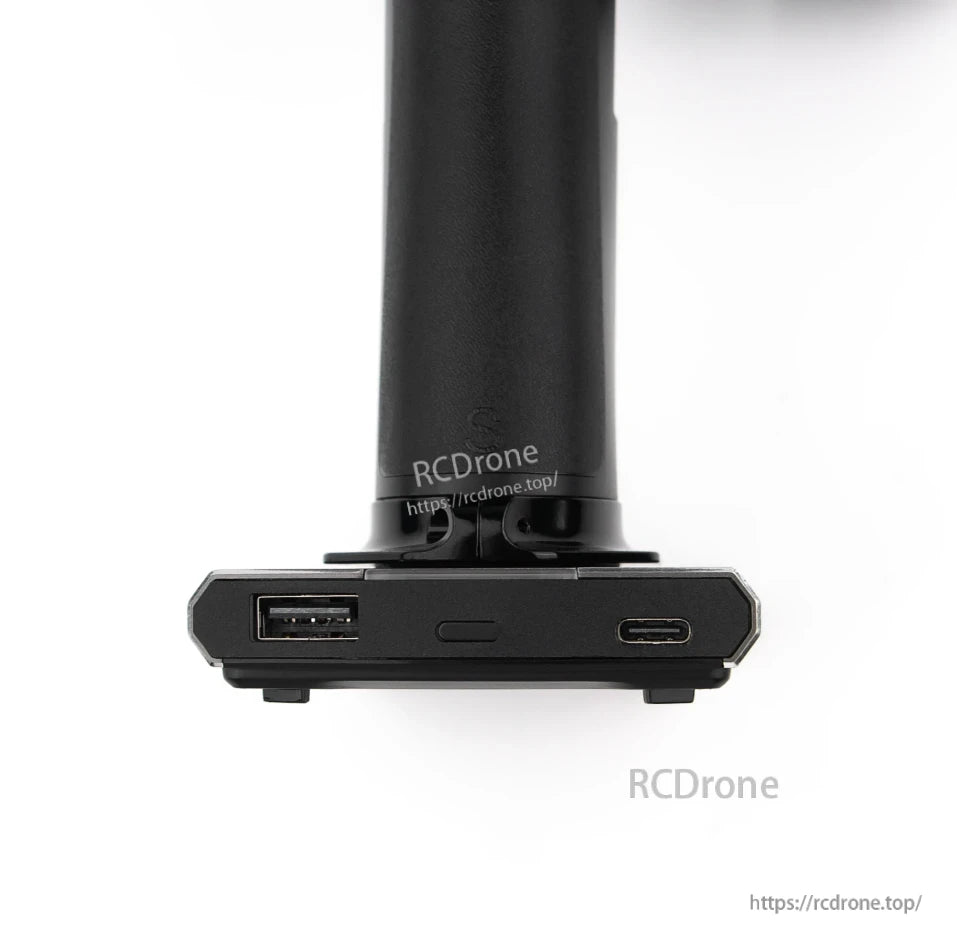 Charging base close-up showing USB-A port and USB-C port on transmitter stand
