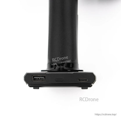 Charging base close-up showing USB-A port and USB-C port on transmitter stand