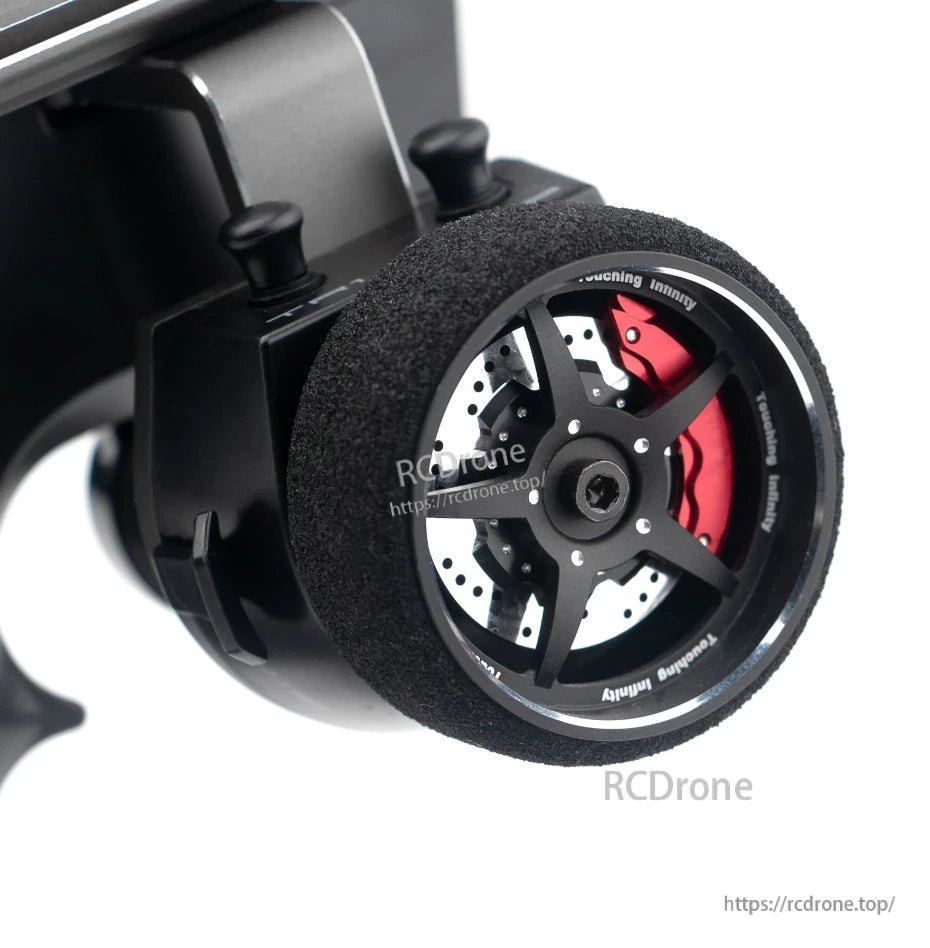 Steering wheel close-up with foam grip and metal spoke design detail on the transmitter