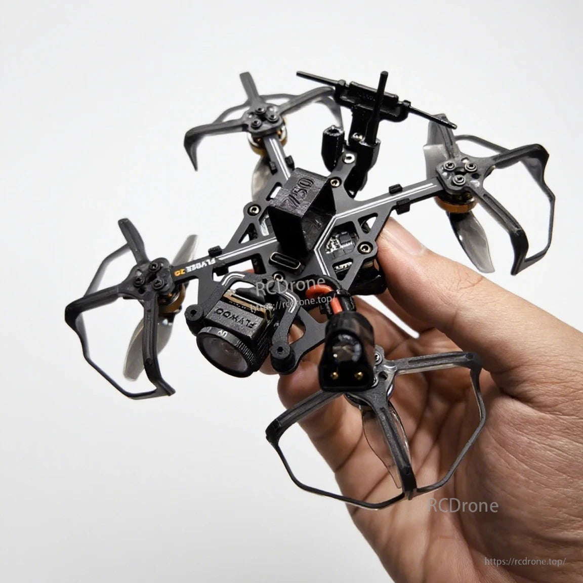 Flybee 16 HD O4 2S ultralight FPV quadcopter with prop guards and front camera, held in hand