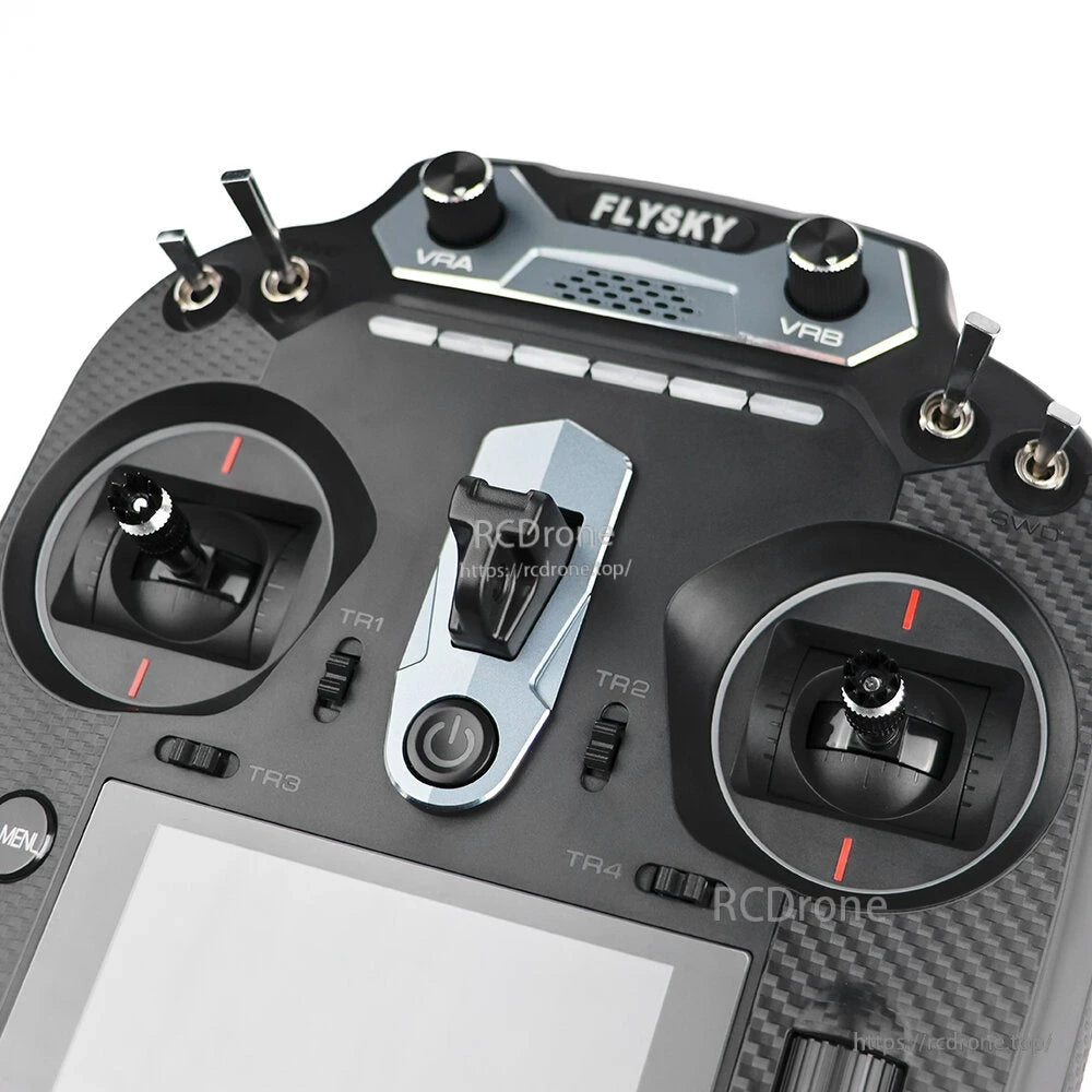 Top control panel close-up on Flysky FS-ST16 showing switches, knobs, and power button area