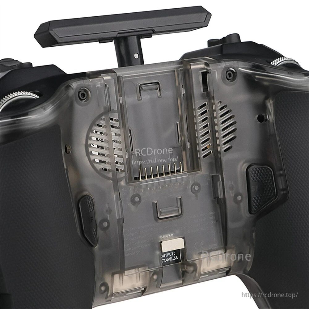 Rear view showing battery compartment cover, speaker vents, and bottom USB-C charging/output port