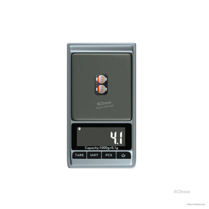 Two 470uF 35V electrolytic capacitors on a digital scale showing 4.1 g total weight