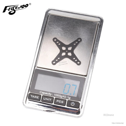 Flywoo X-shaped DJI O3 air unit adapter plate on a digital scale showing 0.7 g weight
