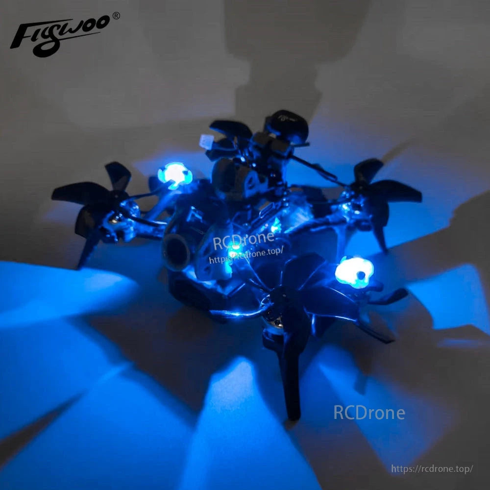 Flywoo digital RGB motor LED set installed on a small FPV quadcopter, with blue lights glowing at each motor