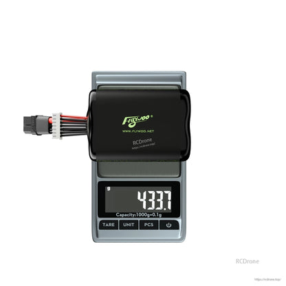Flywoo Explorer 6S 21700 Li-ion battery pack with XT60 and balance lead on a scale reading 433.7 g