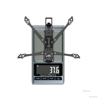 Flywoo Explorer LR 4 Walksnail Frame Kit, Flywoo Explorer LR 4 Walksnail drone frame kit on a digital scale, displaying 37.6 g weight
