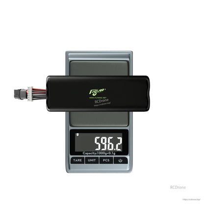 Flywoo Li-ion drone battery pack with XT60 and balance lead on digital scale reading 596.2 g