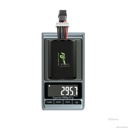 Flywoo 6S Li-ion battery pack with XT60 and balance lead on digital scale reading 295.7 g