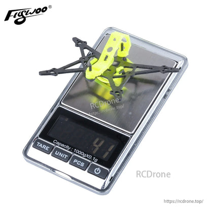 Flywoo Firefly 1S Nano Baby Quad replacement frame kit with yellow canopy on digital scale reading 41