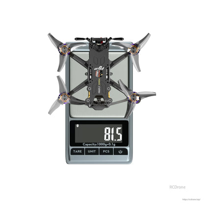 Top view of Flywoo Firefly micro FPV quadcopter on a digital scale reading 81.5 g