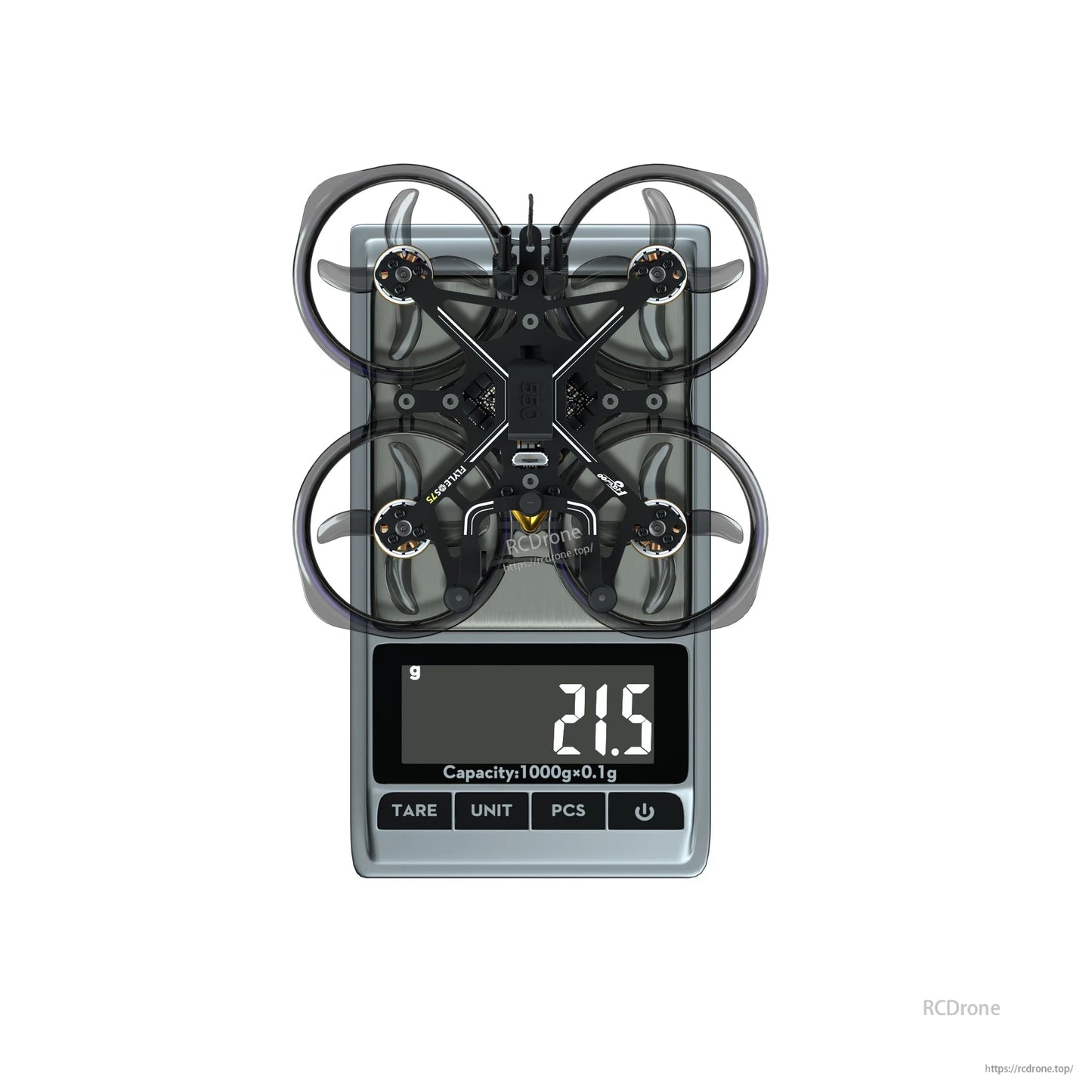 Flywoo FlyLens 75 whoop-style FPV drone on a digital scale with ducted prop guards, reading 21.5 g