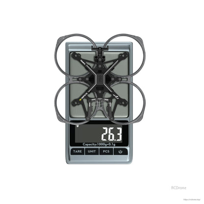 Flywoo FlyLens 85 2-inch whoop drone frame kit on a digital scale, showing 26.3 g weight