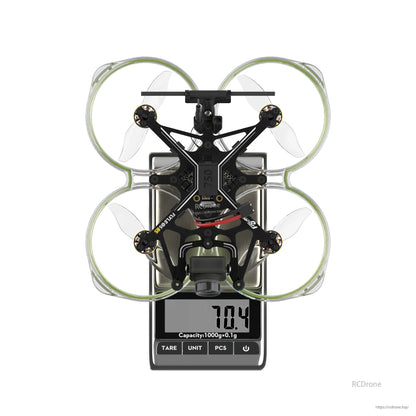 Flywoo FlyLens 85 HD brushless whoop FPV drone on a digital scale showing 70.4 g