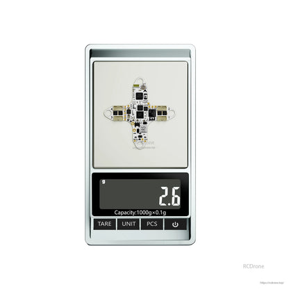 Flywoo GOKU F405 HD 1S AIO flight controller/ESC board on a digital scale showing 2.6 g weight