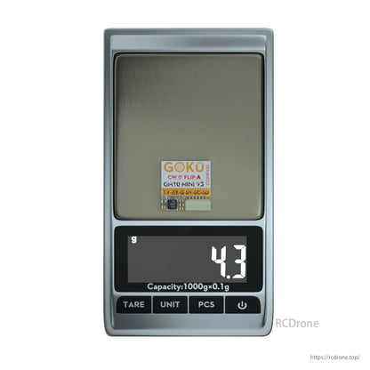 Flywoo GOKU GM10 Mini V3 GPS module on a digital scale showing 4.3 g weight