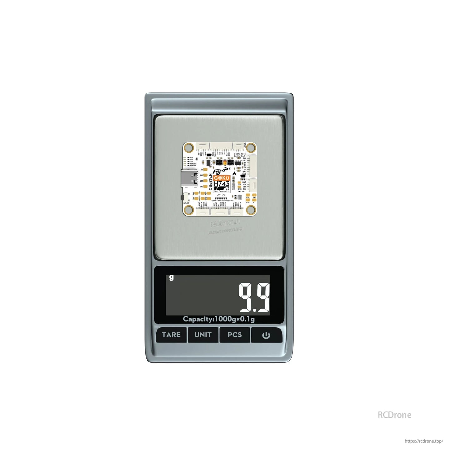 Flywoo GOKU H743 Pro flight controller board on a digital scale, weighing 9.9 g