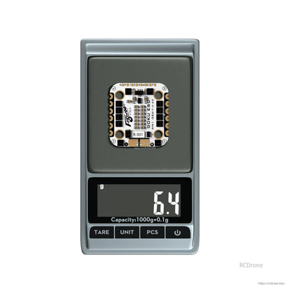 Flywoo GOKU H743 PRO Mini Flight Controller, Flywoo GOKU mini drone control board on a digital scale, with the display showing 6.4 g weight