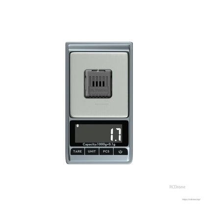 Flywoo O4 Wide Lens, Small Flywoo drone component placed on a digital pocket scale reading 1.7 g