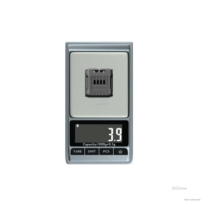 Flywoo O4 wide lens component on a digital scale showing 3.9 g weight