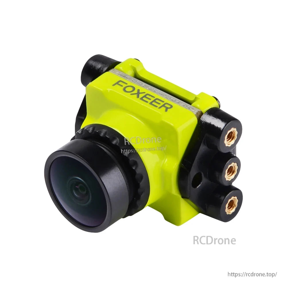 Foxeer micro FPV camera mounted in a yellow extension bracket adapter with side threaded inserts for standard frames