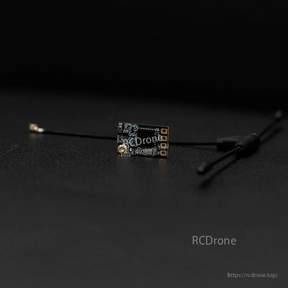 Foxeer ELRS 915/868MHz receiver module with compact PCB, solder pads, and coax antenna lead