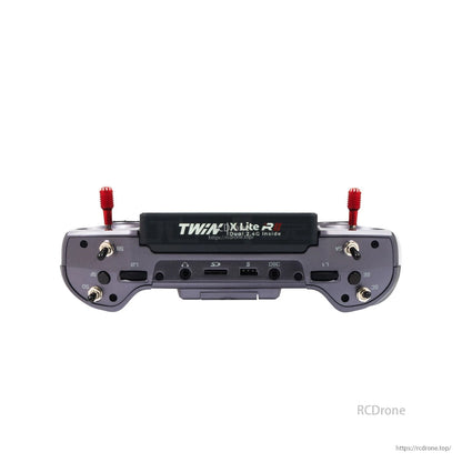 Gray transmitter bottom edge view showing labeled ports and switches with two red stick ends
