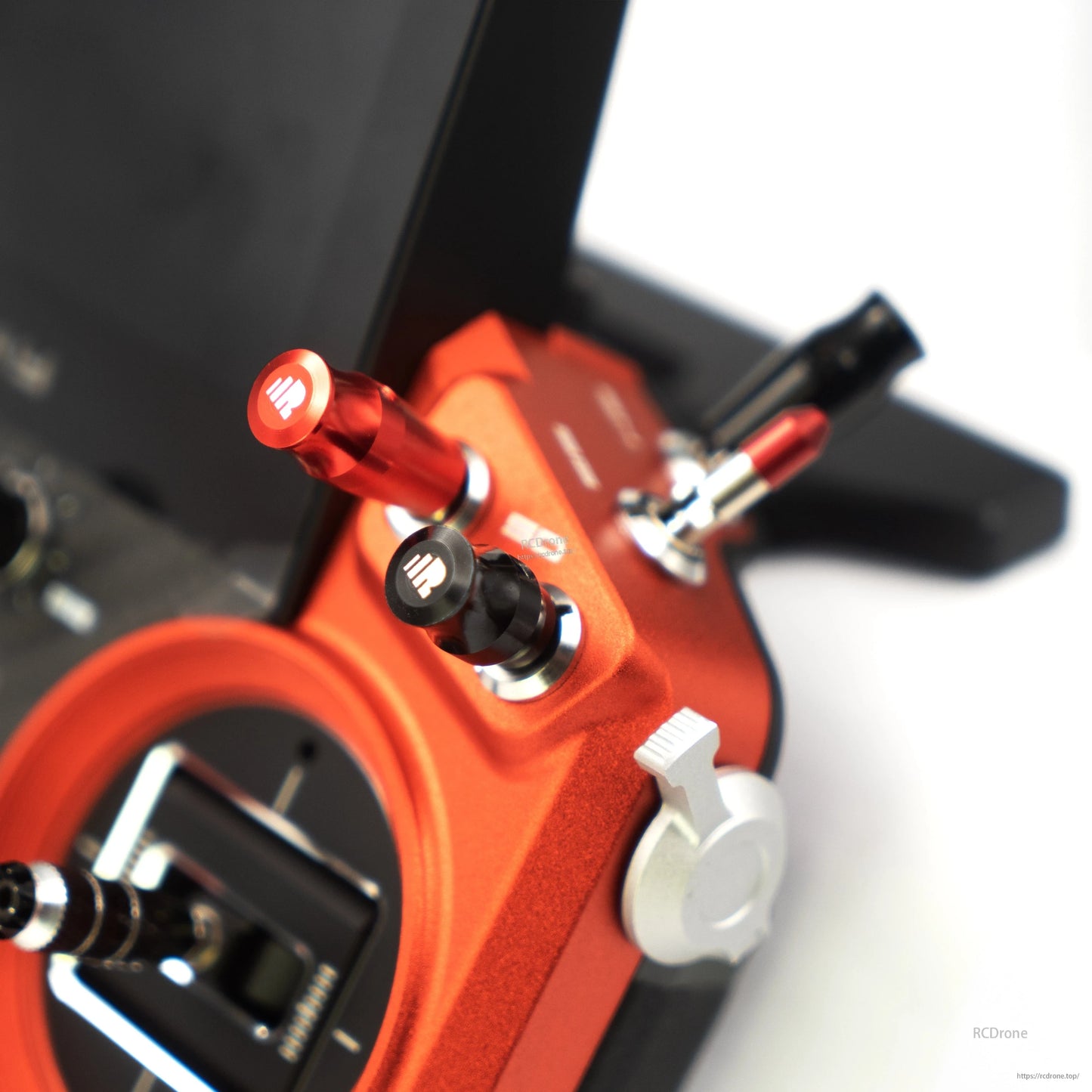 Close-up of FrSky Tandem X20 Pro AeroWing Edition transmitter with red metal control sticks and switches