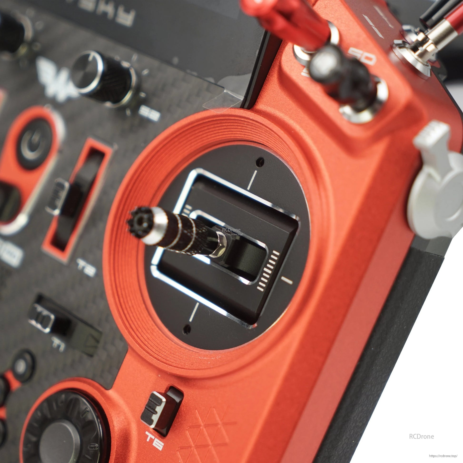 Close-up of FrSky Tandem X20 Pro transmitter gimbal and red metal faceplate with control switches