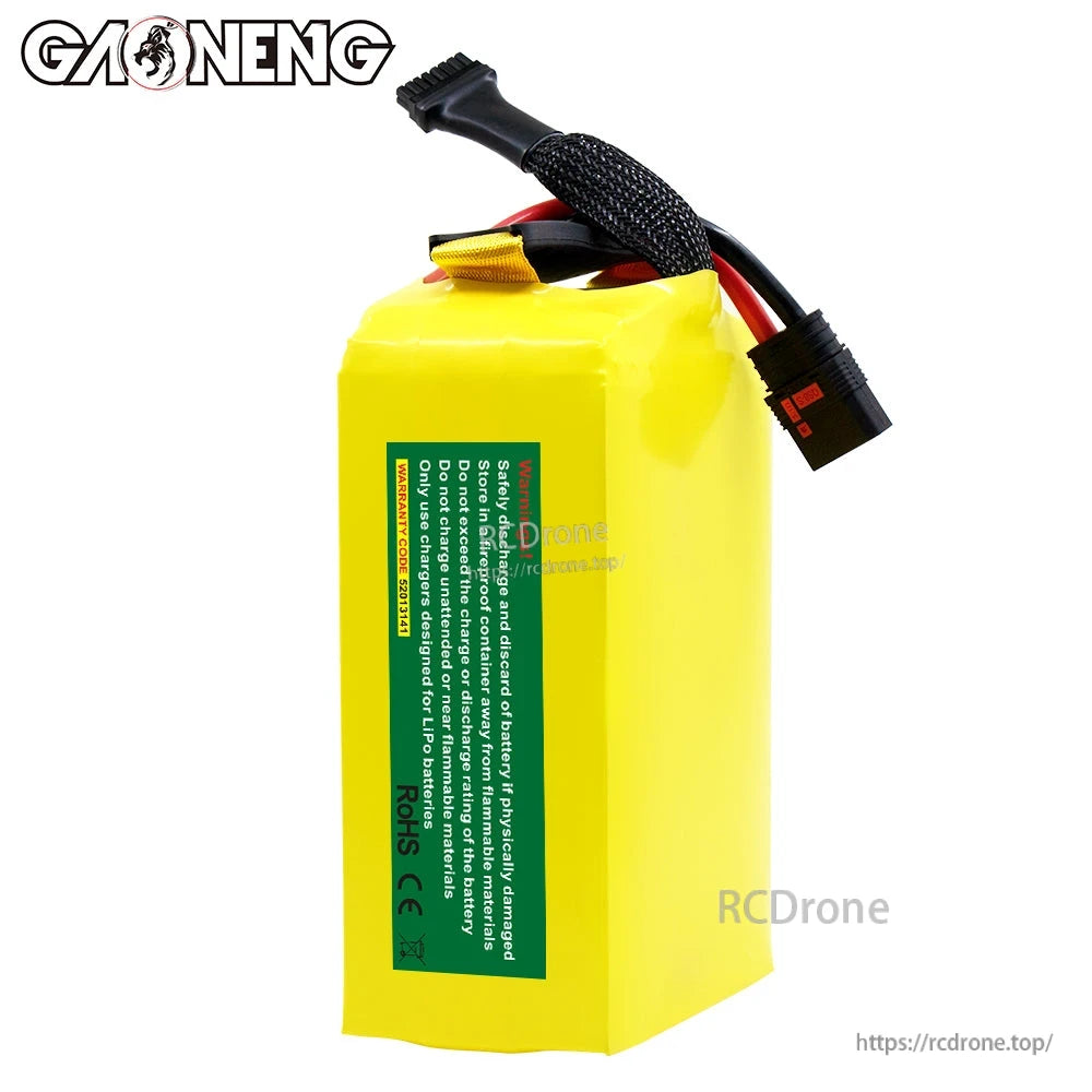 Rear side view of battery pack showing green safety/handling label and top cable exit