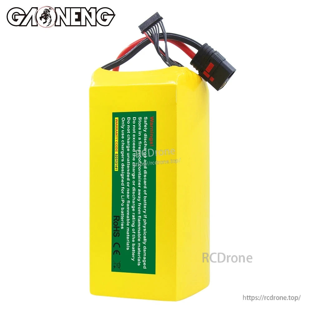 Rear view of yellow GAONENG battery pack with green safety/warning label and attached discharge and balance leads