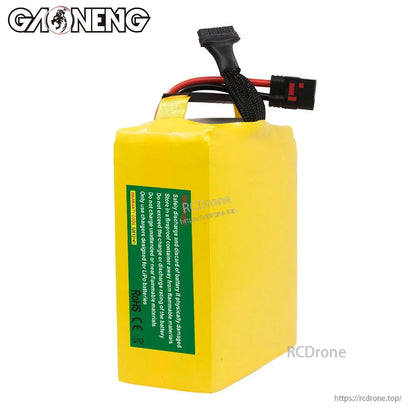 Rear side view of battery pack showing green safety label panel and top balance lead