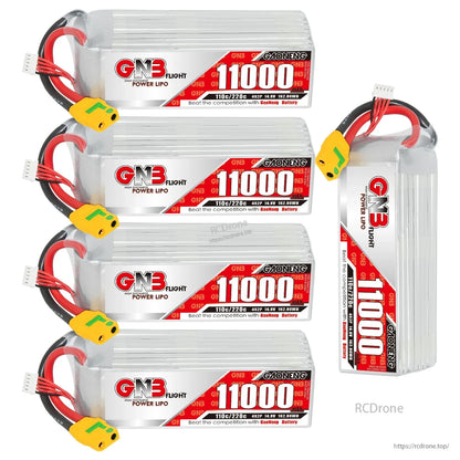 Four GNB 11000mAh batteries stacked plus one standing upright to show side label and thickness